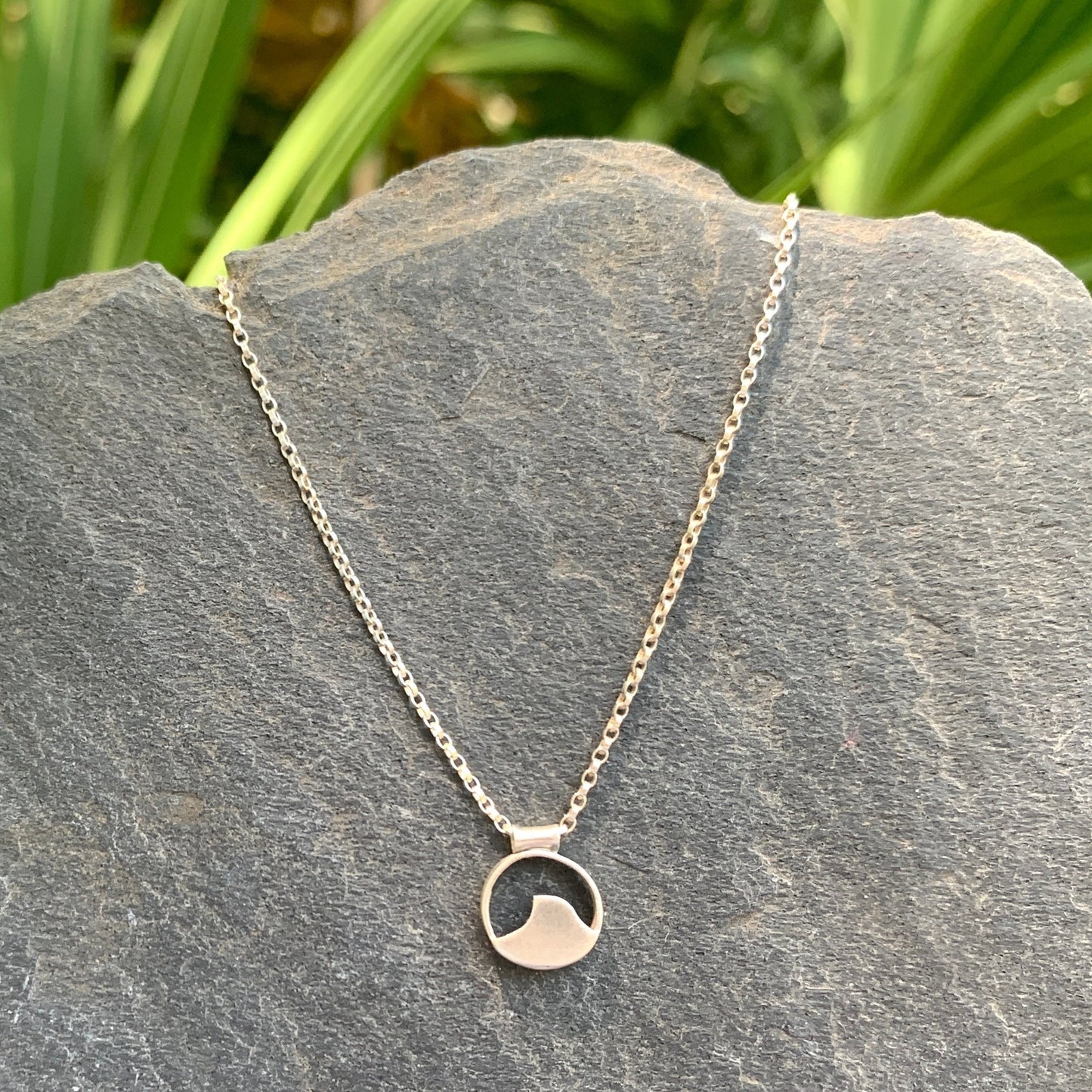 Sterling Silver handmade wave pendant on an adjustable cable chain. Pendant measures just under .5"